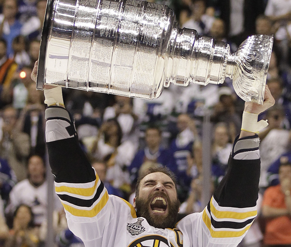 In this June 15, 2011, photo, Boston Bruins defenseman Zdeno Chara hoists the Stanley Cup after the Bruins beat the Vancouver Canucks 4-0 in Game 7 of the Stanley Cup Finals.
