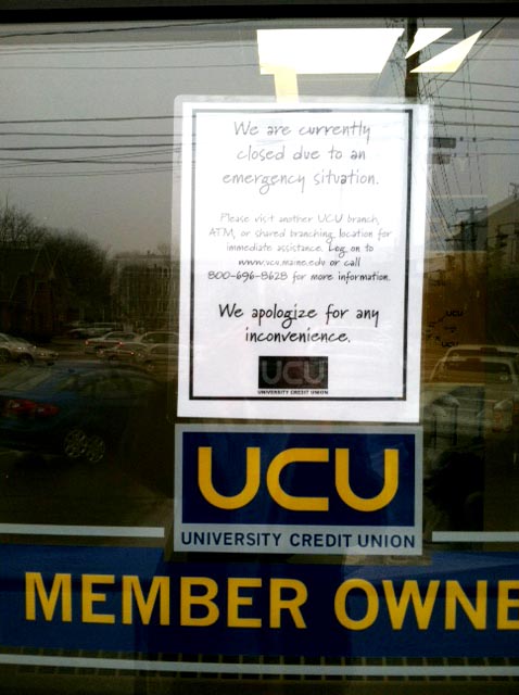 A closed sign appears on the door of University Credit Union following a robbery today.