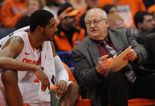 This Nov. 12, 2001 photo shows former Syracuse assistant basketball coach Bernie Fine talking to Fab Melo on the bench during a game against Fordham, in Syracuse, N.Y. The district attorney said on Wednesday, Dec. 7, 2011, he cannot bring charges against Fine because the statute of limitations has passed.