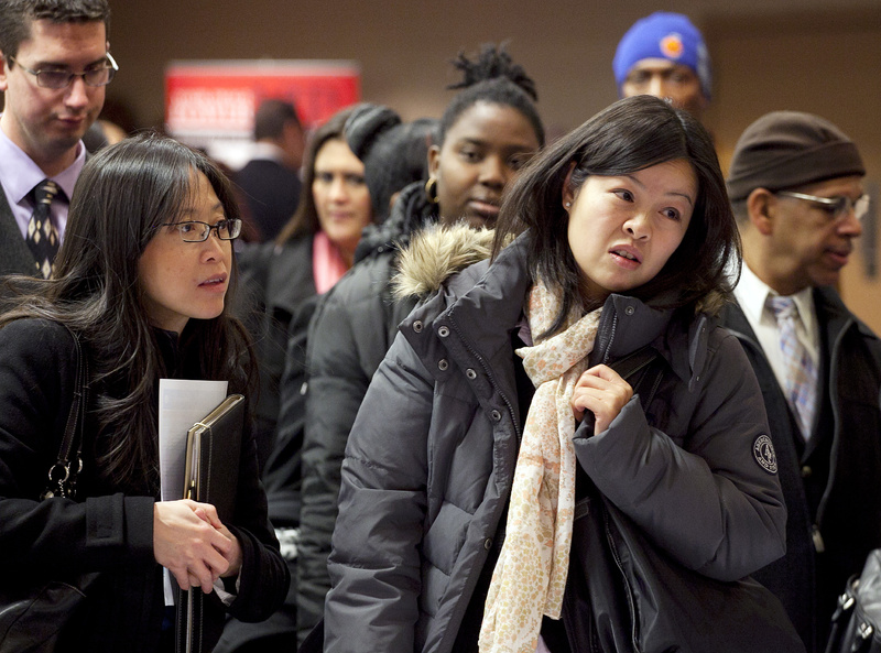 People wait to talk with potential employers at a job fair in New York sponsored by National Career Fairs. Research shows more people are going back to school to hone their job skills.