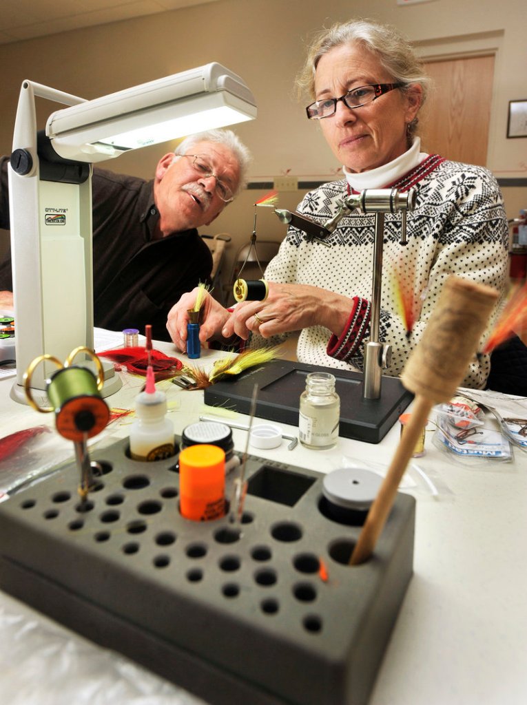 Evelyn King and her Mickey Finn get some much-appreciated attention from Lane Soltesz, a fisherman for 40 years. Both of them are benefiting from fly tying class.