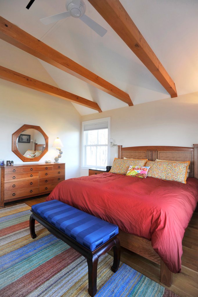 Wood beams and colorful accents stand out in the master bedroom.