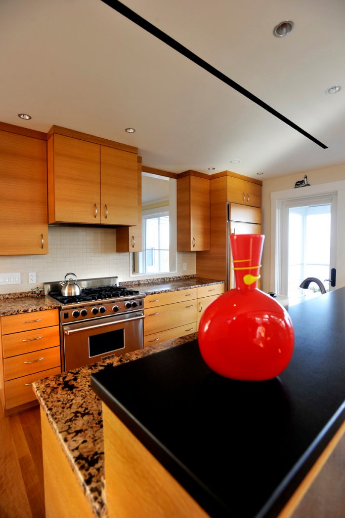 The kitchen features custom wood cabinets and granite countertops.