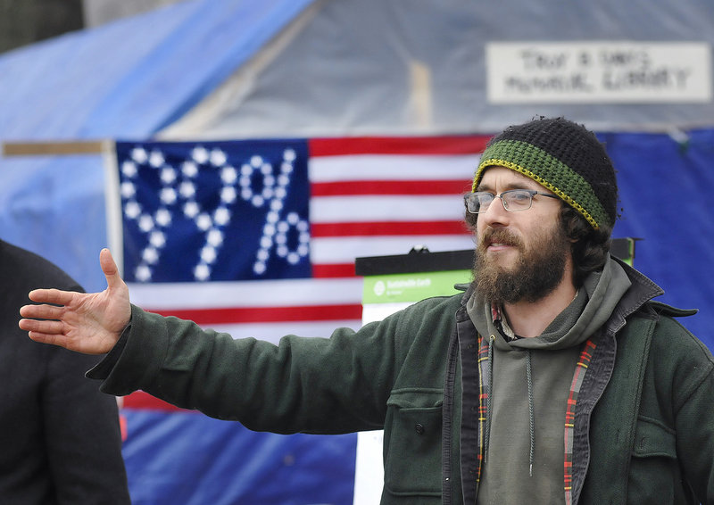 Jonah Fertig of Portland addresses a crowd of about 50 people at a meeting of Occupy Maine in Lincoln Park in Portland on Sunday.