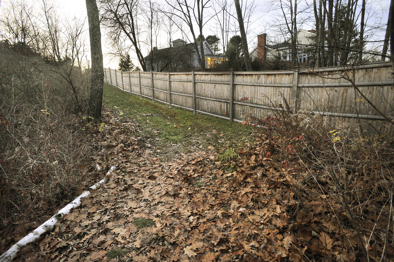 Chris McCormick’s fence runs alongside an easement that provides access to the water. Neighbors say McCormick moved the trail, making it more difficult to navigate.