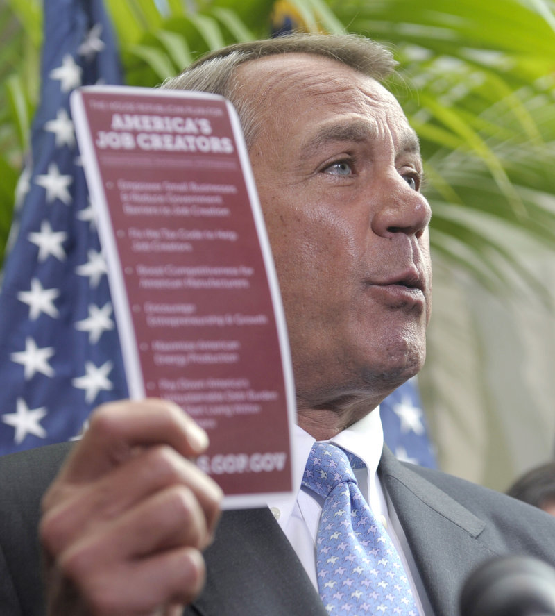 House Speaker John Boehner, R-Ohio, holds a document labeled “America’s Job Creators” while talking to the media after a Capitol Hill meeting Wednesday.