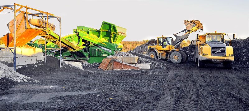 Ecomaine has begun a project to dig up landfilled ash from its waste-to-energy plant and screen it for metals that can be recycled. Above, a front-end loader puts metals into a truck that will transport the material to an onsite storage pile.