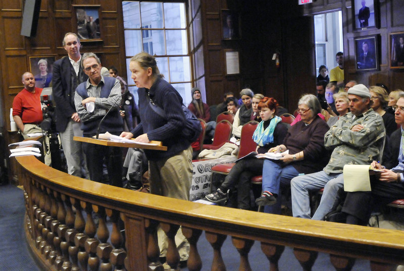 Nancy Page Akers of Portland speaks out against Occupy Maine's application for a permit during a public hearing held by the Portland City Council's Public Safety Committee on Thursday. More people queue up at left to air their own views.