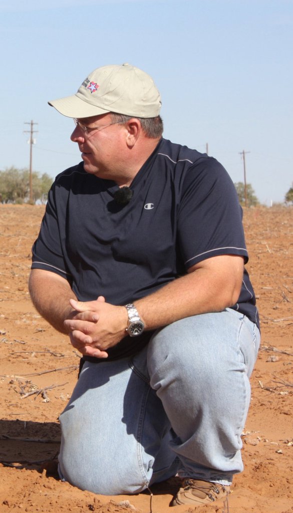 Cotton grower Brad Heffington is shown in a Texas field in October. “I think the threat of a real delivery would be a real deterrent for speculation,” he says.