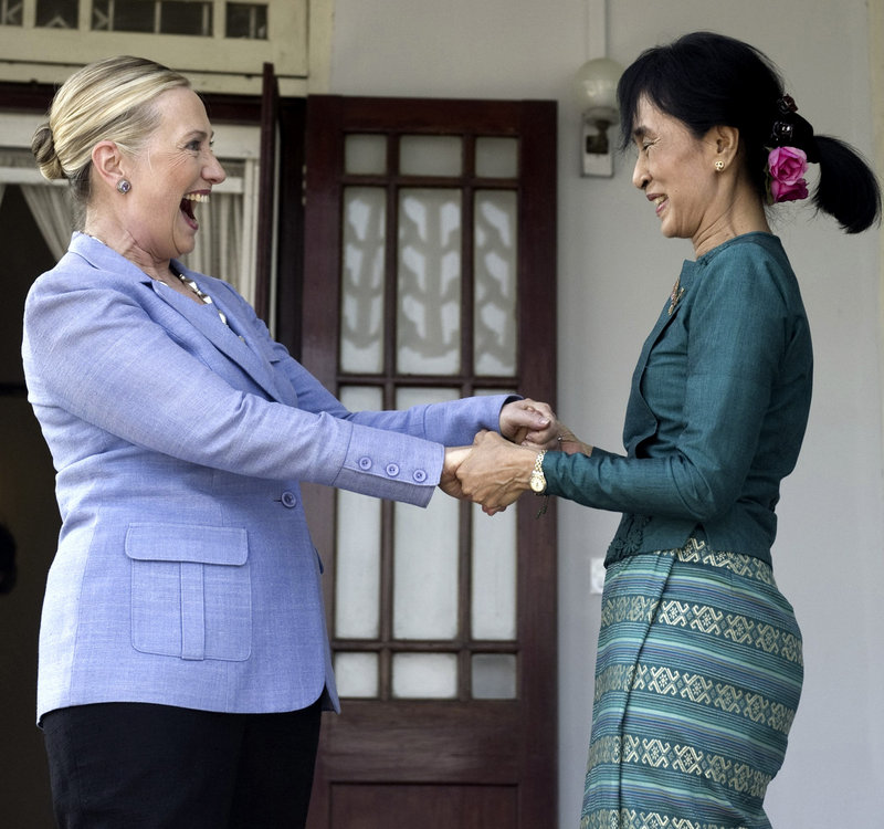 Myanmar’s pro-democracy opposition leader Aung San Suu Kyi, right, and Secretary of State Hillary Rodham Clinton hold hands after meeting in Yangon, Myanmar, on Friday.