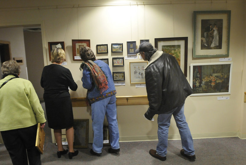People look over Goodwill Industries of Northern New England's sixth biannual "Art for Everyone: A Collection of Donated Art," on Friday.