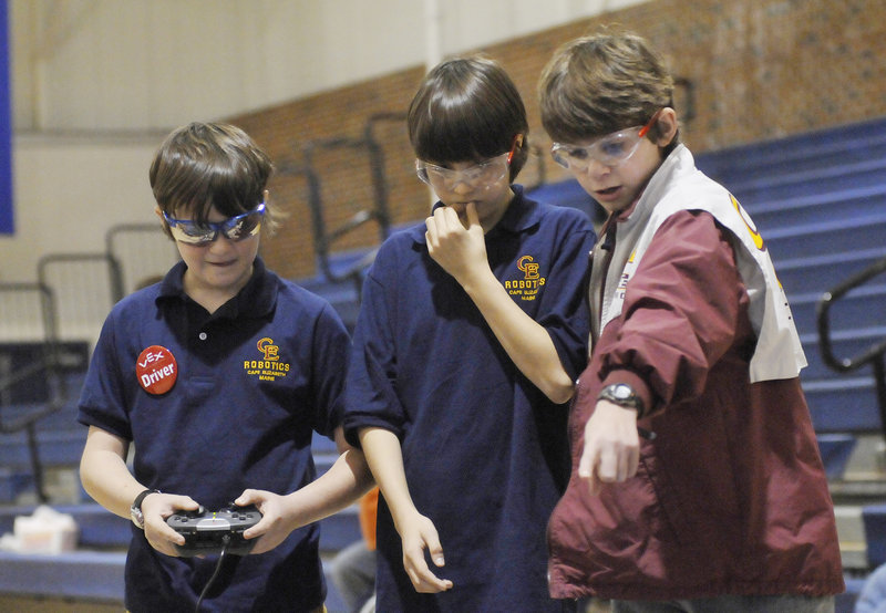 Mac Brucker, Sam Price and Will Corsello of Cape Elizabeth, left to right, operate their robot during competition at the Southern Maine VEX Tournament on Saturday. Even when teams don’t win, participants gain knowledge to use at next year’s competition, fans say.