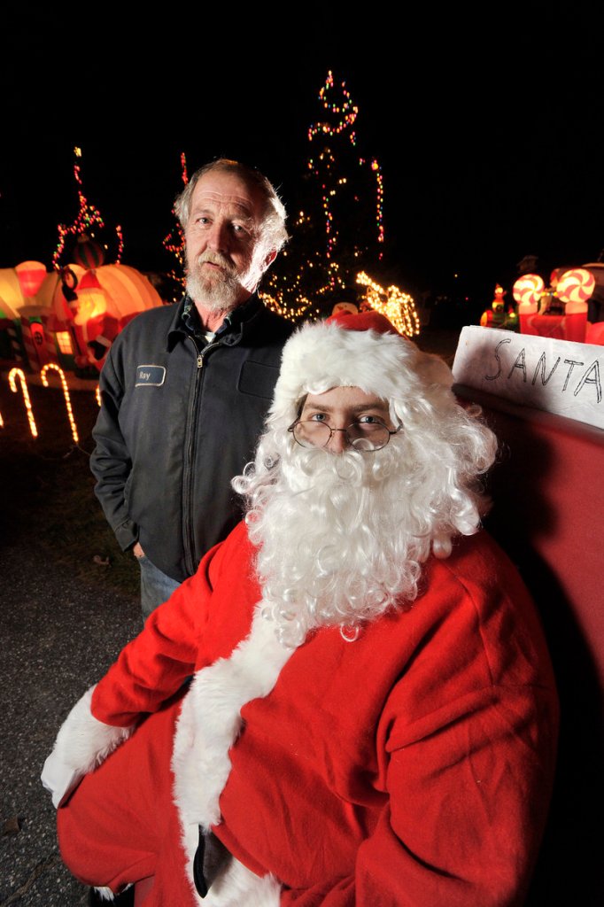 The yard in front of the home of Ray, left, and Mary Benner on Austin Street in Westbrook is aglow with lighted, inflatable Christmas decorations and also features Santa Claus for those who stop by to see the display.