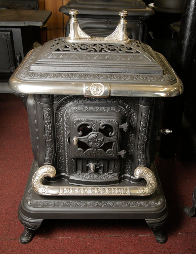 The top of this old Clarion wood stove rotates off to reveal a plate for a cookpot and also a large door to feed wood into the stove from the top.