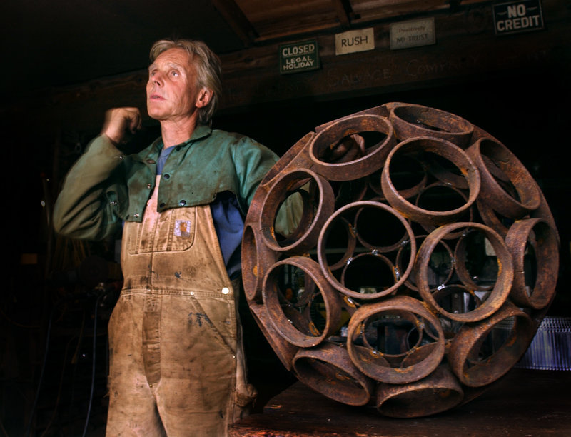 In this 2004 file photo, Dave McLaughlin is shown with a spherical work like the one that Jay Sawyer incorporated into his piece “Late Collaboration.”