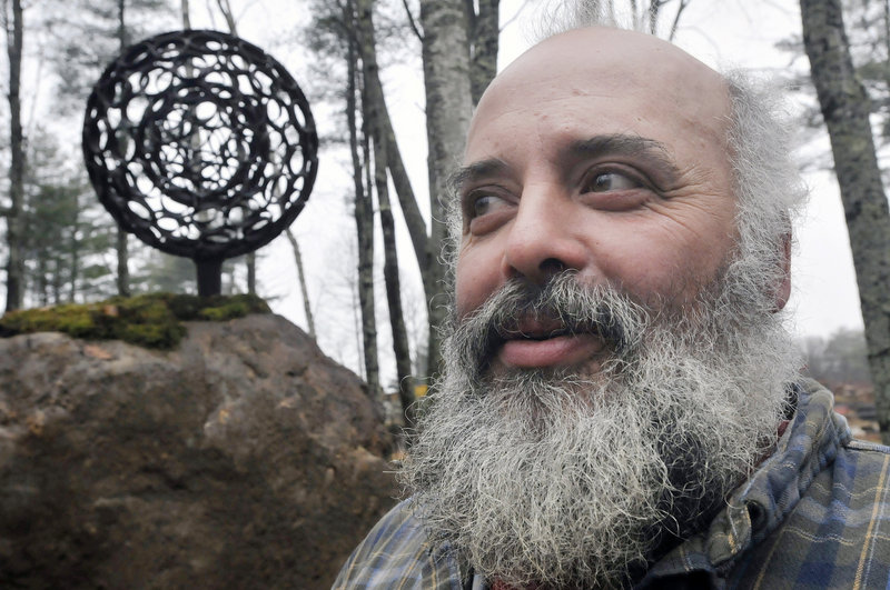 Jay Sawyer suspended a spheroid created by Dave McLaughlin inside one of his own making for “Late Collaboration,” which stands in a sculpture garden on Sawyer’s property in Warren. Sawyer vows to carry forward McLaughlin’s vision for heavy-metal art.