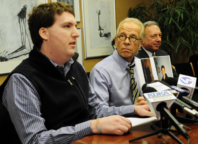 Zachary Tomaselli, left, reads a statement Thursday in Pittsburgh, Pa., where his attorneys, Jeffrey Anderson, center, and Alan Perer announced a lawsuit claiming that Tomaselli was sexually abused by former Syracuse assistant basketball coach Bernie Fine in Pittsburgh in 2002.