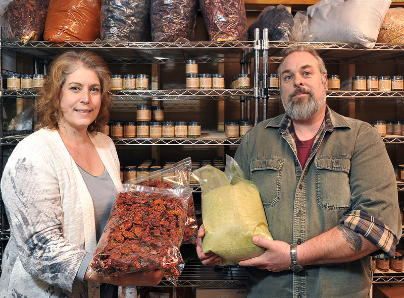 Christine Suydam displays super-hot ghost chiles while her husband Rick shows matcha (green tea) sea salt, one of 20 sea salts available from their Gryffon Ridge Spice Merchants. The company has sold more than 15,000 hand-packaged jars of spices this year.