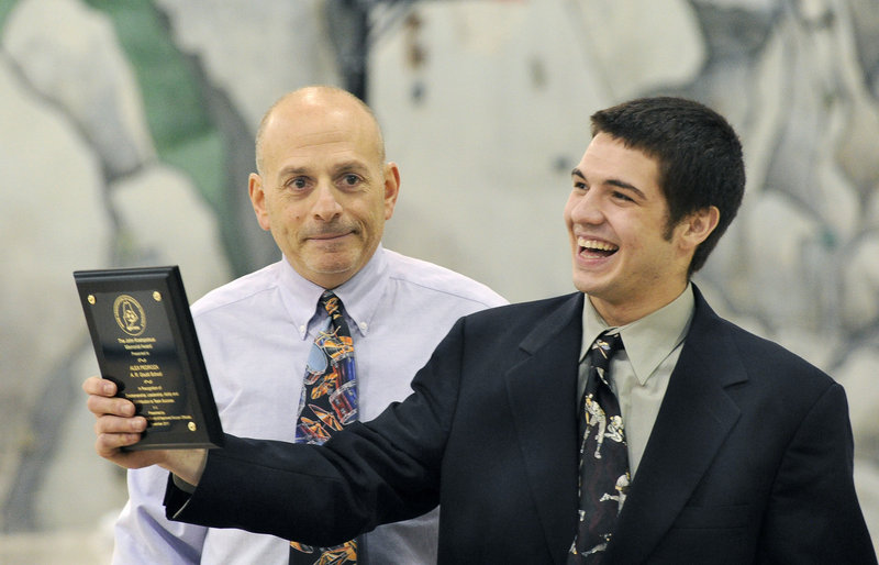 Alex Pedroza of A.R. Gould reacts Friday after receiving the state award for sportsmanship from Ron Kramer, representing the sponsoring officials group.