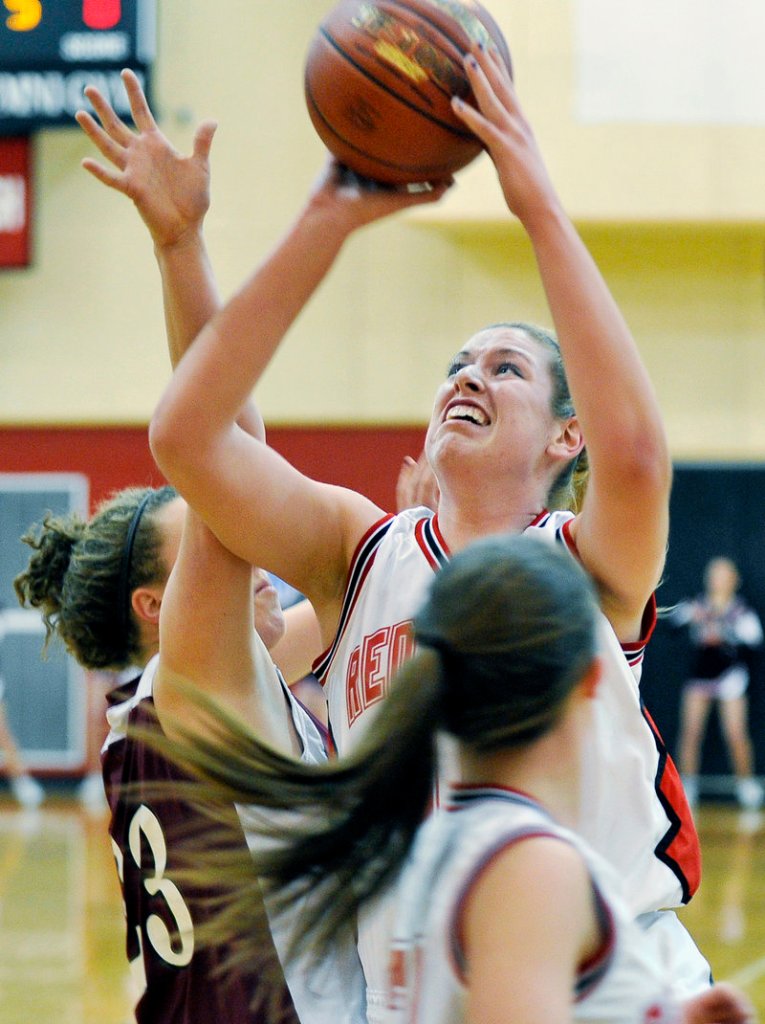 Brittany Bona of Scarborough puts up a shot over Gorham’s Lexi Merrifield after grabbing a rebound. Bona finished with 13 points.