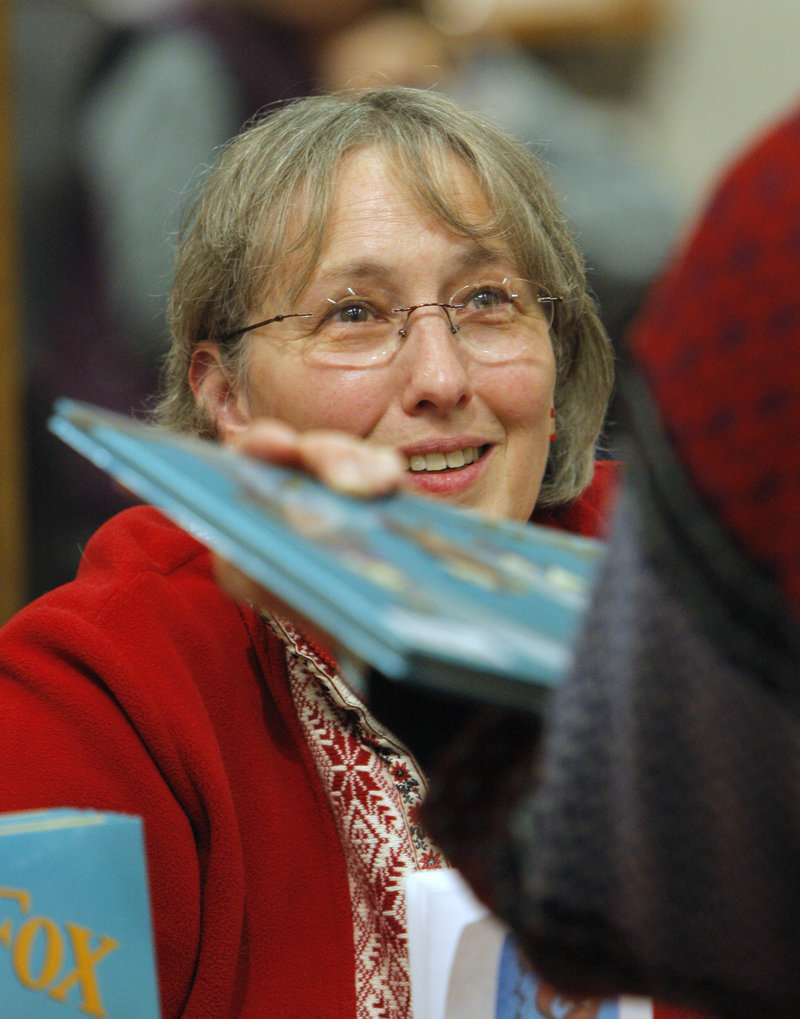 Wendy Ulmer, a children’s book author from Arrowsic, chats with a shopper after signing her book during the Holiday Book Festival at L.L. Bean in Freeport on Saturday.