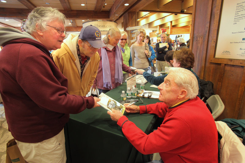 During the book festival in Freeport on Saturday, Linda and Percy Smith, left, of Gray talk with Donn Fendler, co-author of “Lost Trail: Nine Days Alone in the Wilderness,” after he signed a copy of the graphic novel based on his boyhood experiences. Percy Smith said that in his youth he hiked the same trail on Mount Katahdin where Fendler got lost at age 12 in 1939.