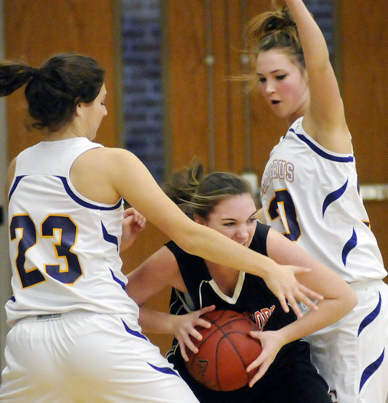 Jillian Sheltra of Biddeford looks for a way out of pressure defense applied by Victoria Nappi, left, and Eden Monsen of Cheverus during their schoolgirl basketball opener Saturday.