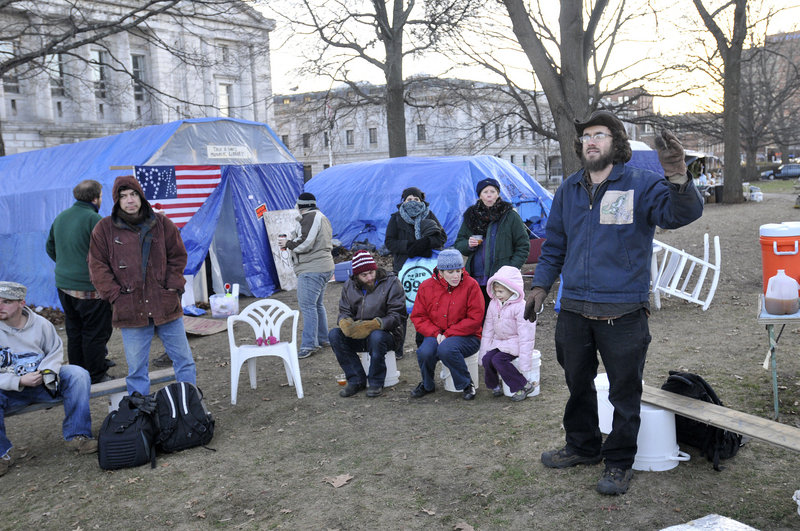 Jonah Fertig of Portland facilitates a meeting at the Occupy Maine encampment in Portland’s Lincoln Park on Sunday. In addition to authorizing legal action against the city, several protesters for the first time openly broached the topic of civil disobedience.