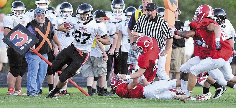 Gardiner’s Alonzo Connor is forced out of bounds during a football game with Cony High School in Augusta. Guidelines in Maine schools now help athletes and other students while they recover from concussions.