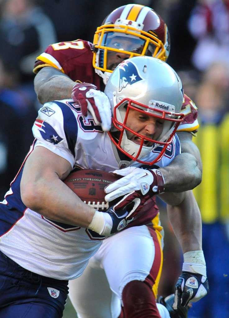 DeAngelo Hall tries to bring down New England’s Wes Welker, who scored a touchdown in the win against the Redskins.
