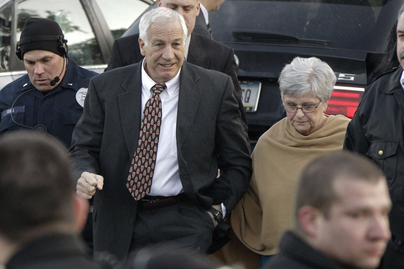 Jerry Sandusky, center, and his wife, Dottie, arrive Tuesday at the Centre County Courthouse in Bellefonte, Pa., where he pleaded not guilty to charges of sexually abusing 10 boys.