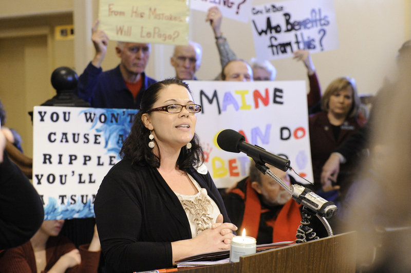 Shanna Rogers of Lewiston speaks against state health care cuts during the rally in the Hall of Flags at the State House in Augusta on Wednesday.