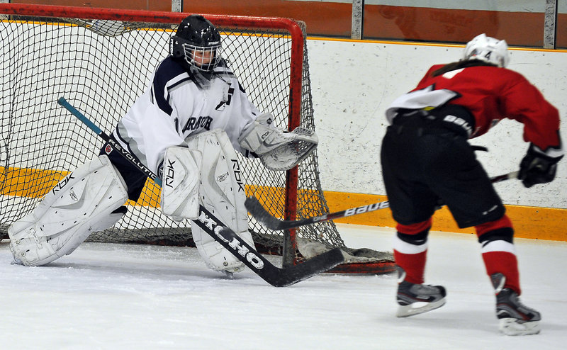 Hannah Williams of Yarmouth-Freeport stands her ground Wednesday to block a bid by Taylor Landry of Leavitt-Edward Little in the first period. Landry finished with three goals as Leavitt-Edward Little earned a 5-1 victory at Travis Roy Arena in Yarmouth.