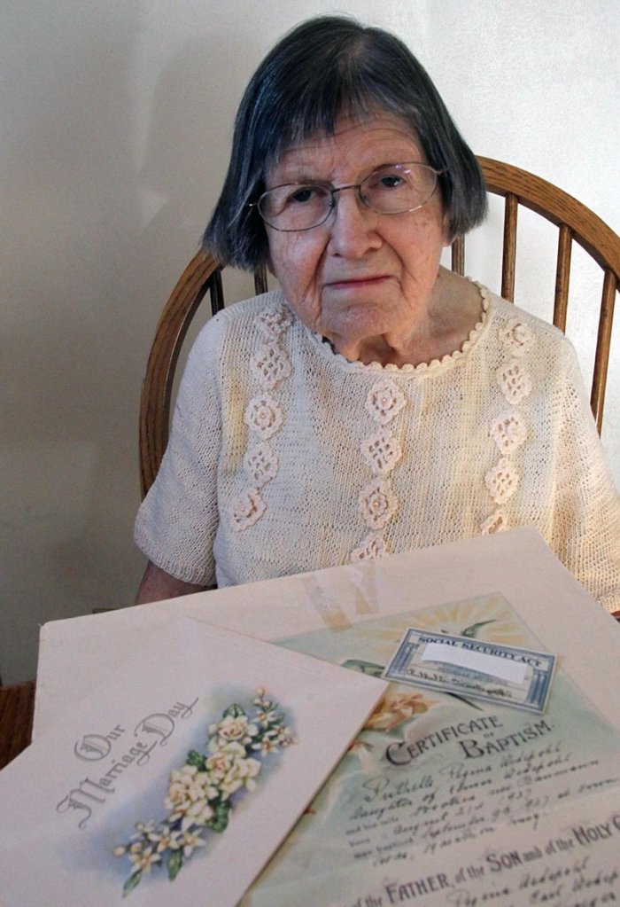 Ruthelle Frank, at home in Brokaw, Wis., shows some of the documents that were not good enough to get her a state voter ID.