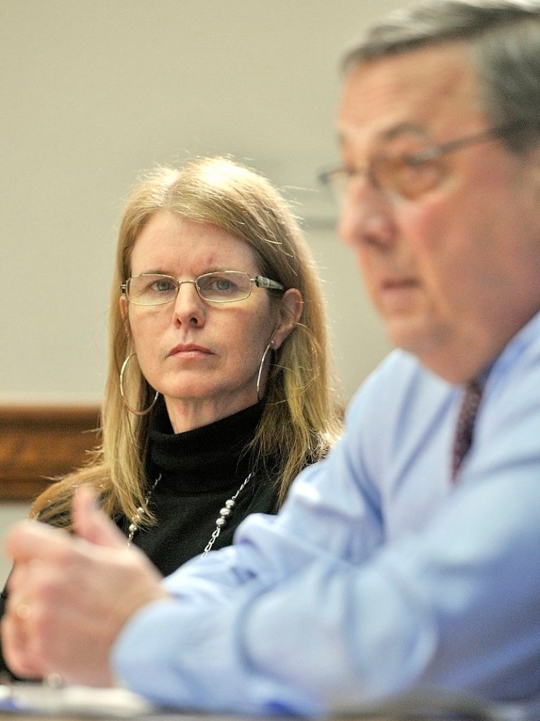 Department of Health and Human Services Commissioner Mary Mayhew, left, listens to Gov. Paul LePage during a news conference on Thursday at the State House in Augusta.