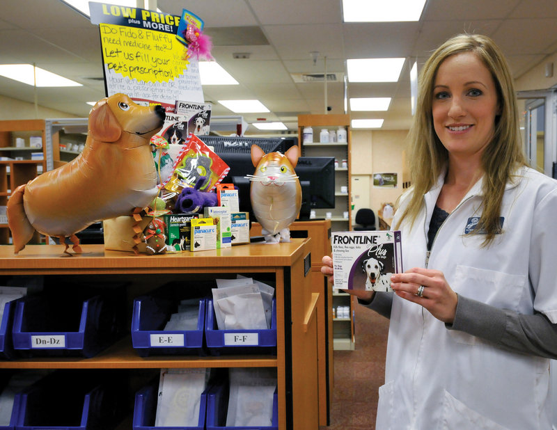 Kroger assistant pharmacy manager Kimbra Richey holds Frontline Plus for dogs in Fort Worth, Texas. Kroger has begun to tap the profitable pet medicine business.