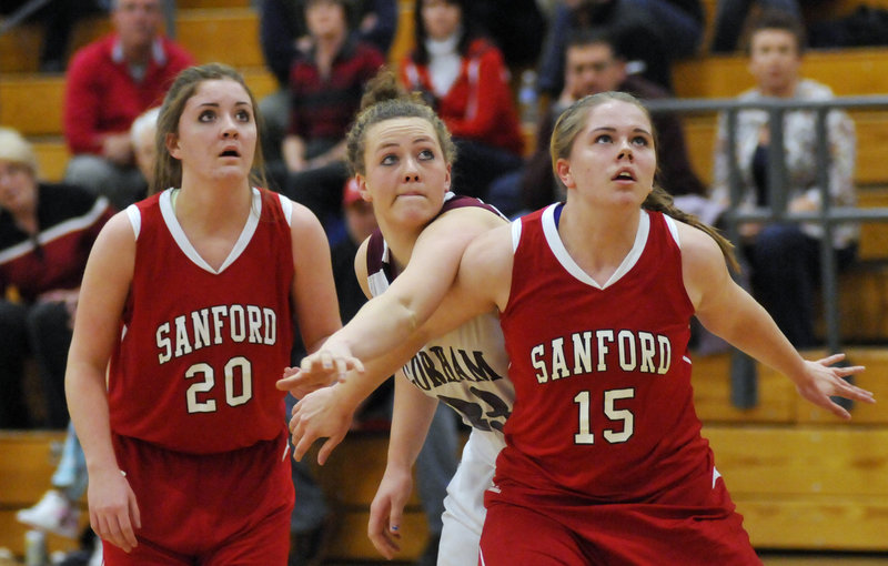Shelby Paiement of Sanford boxes out Gorham's Lexi Merrifield in the battle for a rebound as Katelyn King looks on Friday night. Sanford moved to 3-0 with a 41-38 win.