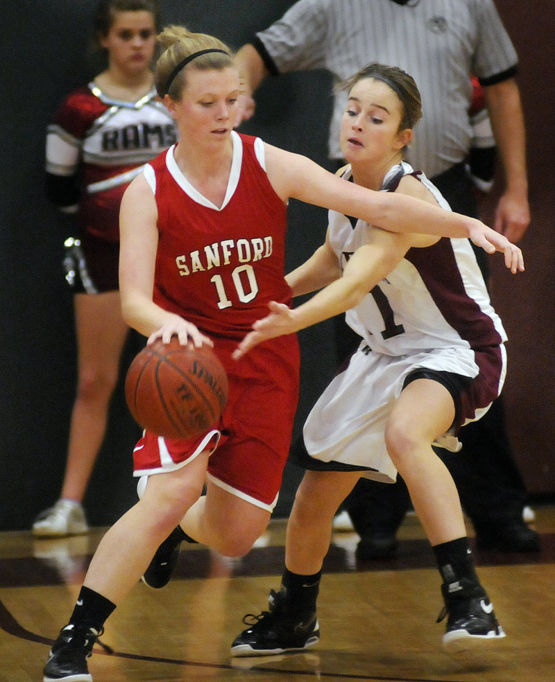 Samantha Adams of Sanford drives against Kiersten Turner of Gorham during their SMAA game in Gorham. Adams scored seven points to help the Redskins hold on for a 41-38 win.
