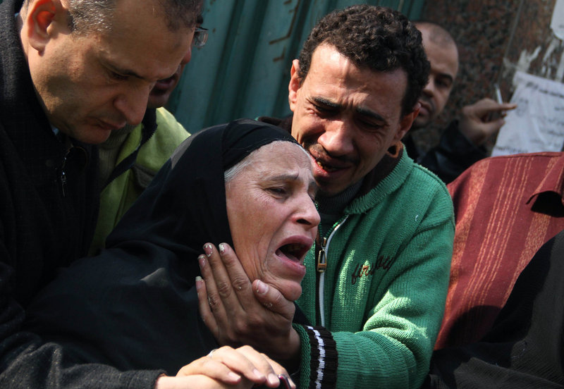 Relatives of Egyptian protesters who were killed during the latest clashes with soldiers mourn in Cairo on Saturday. At least nine people were killed and more than 300 were injured in fighting after the military tried to crush protests in Tahrir Square Friday and Saturday.