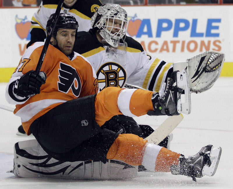 Maxime Talbot of the Flyers crashes into Bruins goalie Tim Thomas during Saturday’s game in Philadelphia. Thomas made 31 saves in a 6-0 victory.
