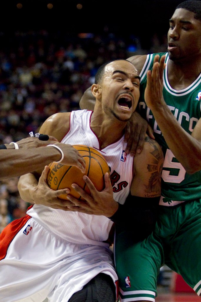 Jeryd Bayless of the Raptors drives to the basket while being defended by Boston’s E’Twaun Moore in the first half of Sunday’s NBA exhibition game at Toronto. The Celtics won, 76-75.