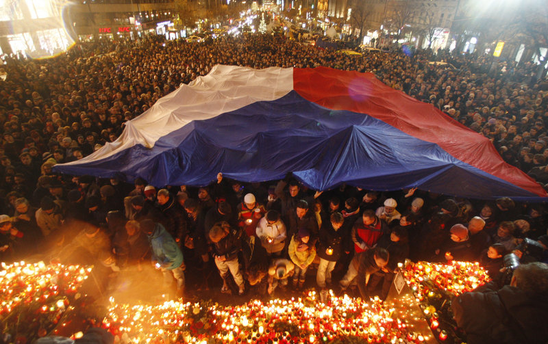 Thousands of people gather under a Czech national flag in Wenceslas Square in Prague, Czech Republic, on Sunday to mark the death of former Czech President Vaclav Havel.