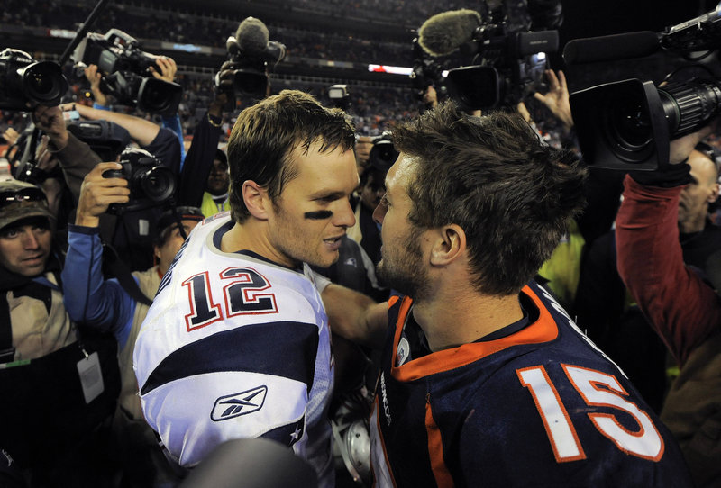 Fellow QBs Tom Brady and Tim Tebow meet at midfield after Sunday’s game. Brady threw for two TDs and ran for another.