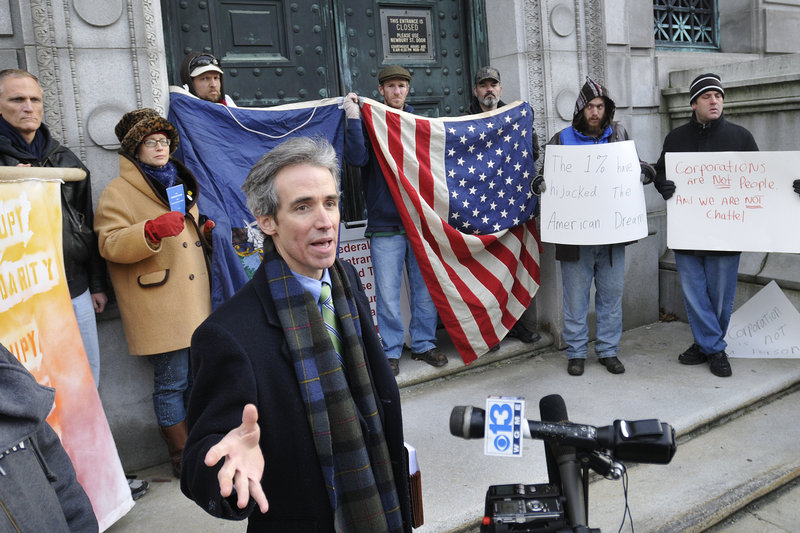 John Branson, a lawyer with Occupy Maine, speaks to the media outside court Monday. “The city manager recognized this as First Amendment activity from the start,” he said.