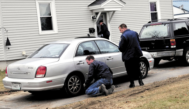 State police Detective Scott Bryant watches as a tow truck operator hooks on to the first of two vehicles that police seized from the driveway of the home where Ayla Reynolds lives with her father, 24-year-old Justin DiPietro. The black Ford Explorer was registered to DiPietro, according to motor vehicle records.