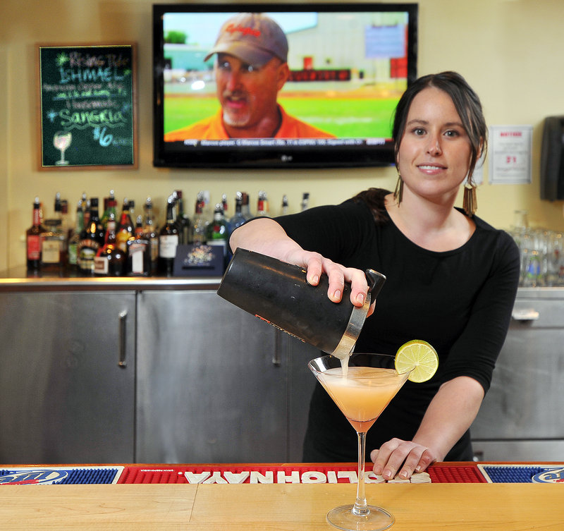 Colleen Foley, bar manager at the Snow Squall, makes one of its many specialty martinis, a Grapefruit Martini. The reviewer enjoyed a Lavender French 75, which includes locally made mead.