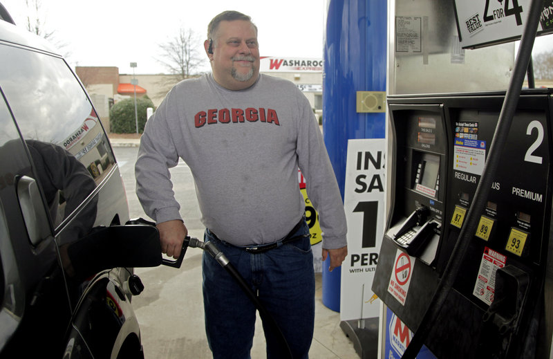 Michael Reed fills his gas tank last week in Charlotte, N.C. Out of work since 2009, he feels the pain of high gas prices more than many others. “I try to drive as little as possible so it doesn’t take such a chunk out of my wallet,” he said.