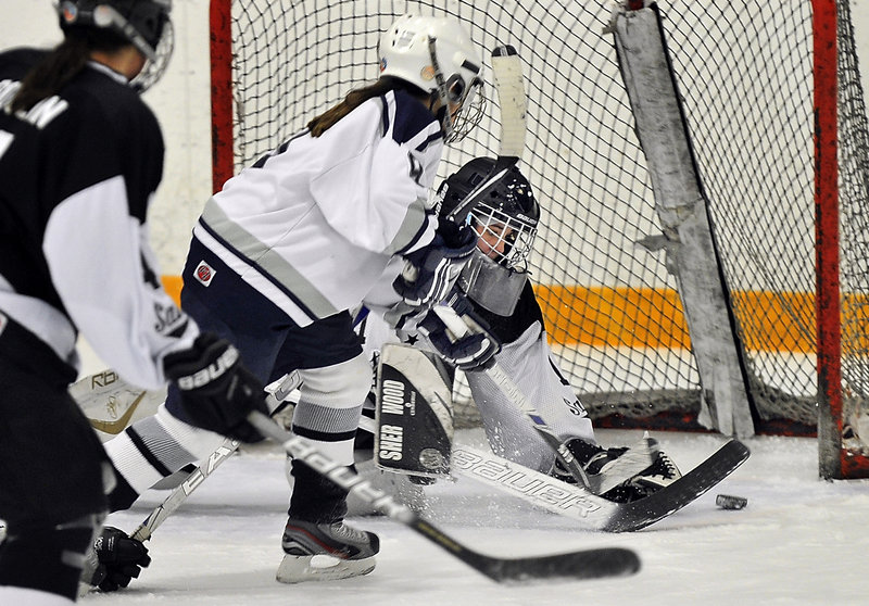 Michelle Robichaud of Yarmouth/Freeport looks for the rebound after a save by St. Dom’s goalie Taylor Bergeron. Robichaud had a goal and an assist for the Clippers.