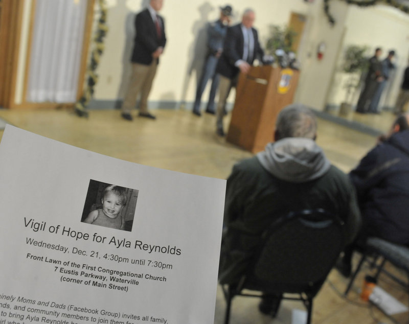 Waterville police hand out fliers, at left, as Chief Joseph Massey, at the podium, speaks to members of the media regarding the investigation into the disappearance of Ayla Reynolds at a city hall news conference Tuesday.