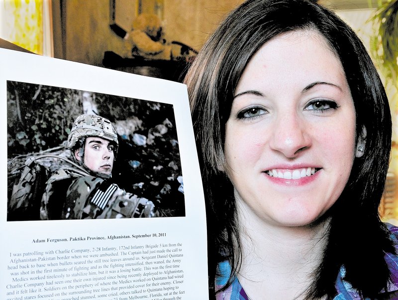 Britanny Miller, in Maine for Christmas, holds a Time magazine photograph of her husband, Spc. Michael Miller, taken in Afghanistan. The image is one of Time’s Top 10 Photos of 2011.